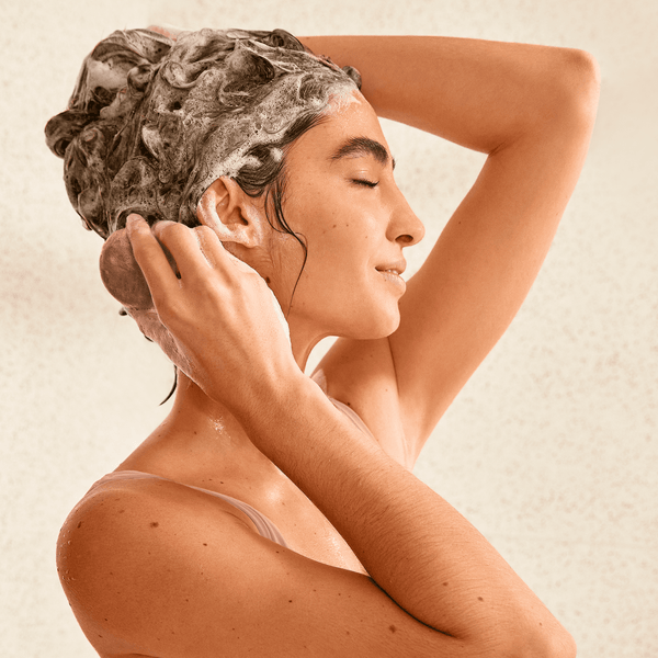 Girl applying shampoo bar