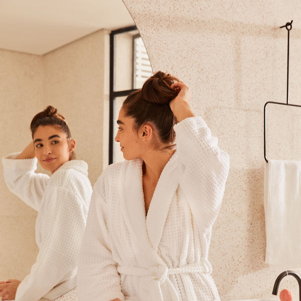 Girl checking her hair on the mirror