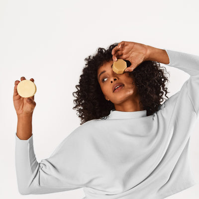 Girl holding the Curl Definer Conditioner Bar and Curl Defining Hair Mask
