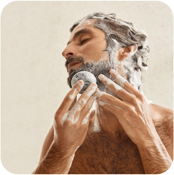 Man lathering Bars Over Bottles detox shampoo bar: the best shampoo for oily curly hair around his beard