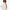 Elegant woman holding a big round white thick paper symbolizing Bars Over Bottles oily hair conditioner